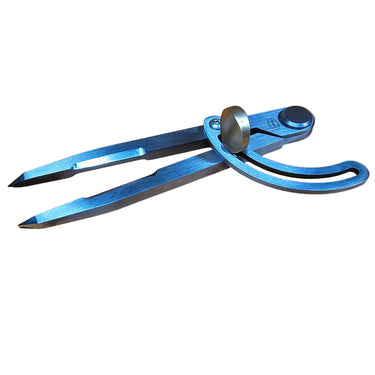 A French style wing divider tool lying on a white background