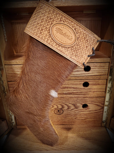 Custom made stocking with hair hide texture, and a tooled leather top section.