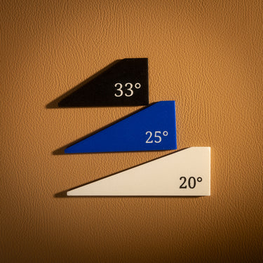 Three triangular acrylic templates for creating a basket weave pattern on leather goods, laid out on a brown textured leather background.