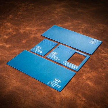A set of blue acrylic templates used to create a custom tri-fold wallet with capacity for 6 credit cards. Laid out on a brown leather textured background.