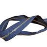 A Yard of YKK brand zipper, brass and black in color, displayed on a white surface.