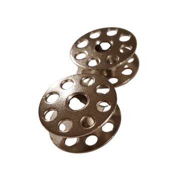 Two metal bobbins placed on a flat white surface, typically used in sewing machines.