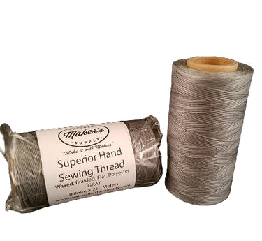 Two spools of MLS Superior Hand Sewing Thread, one displayed vertically and the other horizontally, with the brand name and 'Superior Hand Sewing Thread' text visible on the packaging.