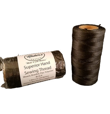A spool of black hand sewing thread next to its packaging which reads 'Superior Hand Sewing Thread'.