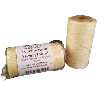 Two spools of MLS Superior Hand Sewing Thread, one inside a clear plastic packaging labeled with the brand, color 'Cream', and the other spool is beside it outside the packaging.