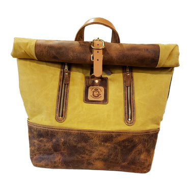 A yellow and brown roll top rucksack made of canvas and leather, displayed on a white background.