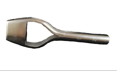 A metal bag punch tool resting in front of a white background.