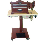 A Cobra Class 14 Splitter machine used for splitting leather, featuring a steel blade and a hand crank, mounted on a wooden table.