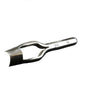 A metal strap end punch tool lying on a white surface.