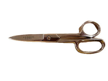 A pair of high quality EZ Cut shears/scissors with a shiny nickel finish, lying on a piece of leather.