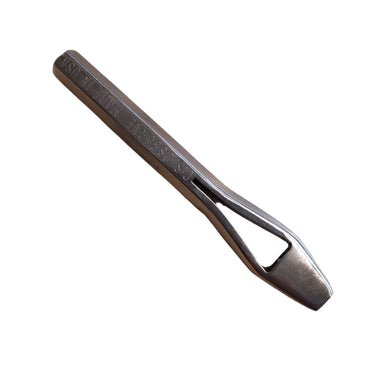 A quality metal punch tool lying on a white surface, stamped with the letters "Made in USA"
