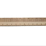 A leather centering ruler laid out on a flat white background, including tick marks on the ruler.