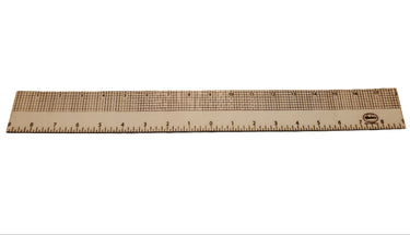 A leather centering ruler laid out on a flat white background, including tick marks on the ruler.