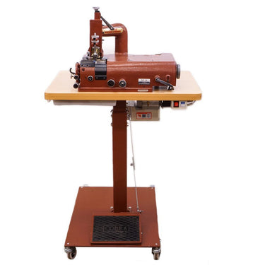 A bell skiver machine mounted on a table with wheels, primarily used for cutting leather.