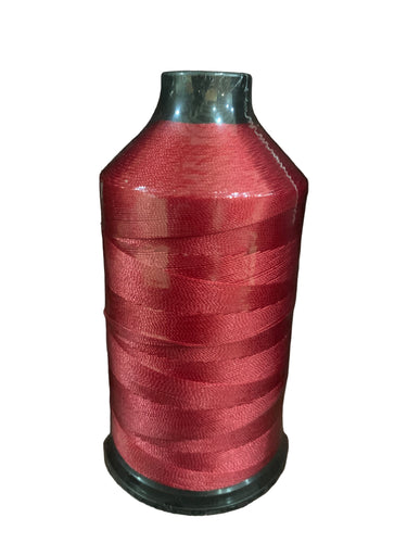 A spool of red bonded nylon thread for use with sewing machines.