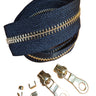 A yard of YKK EVERBRIGHT zipper in brass and black, displayed alongside zipper sliders and other components, against a white background.