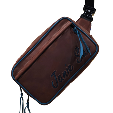 Brown leather waist bag with blue accents on a white background