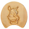 A leather tooling pattern featuring a whimsical horse face design, placed on a white background.