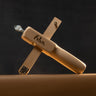 A wooden strap cutter branded with the "Ivan" logo, displayed on a brown leather surface in front of a dark background. 