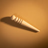 A wooden edge slicker for leather projects laid out on a textured light brown leather background. 