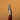A `bleeder' tool, used for leather crafting and tooling. Laid out on a solid brown background. 