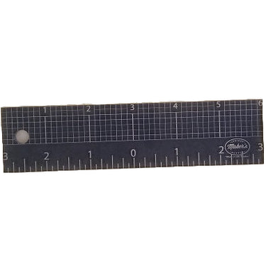 A black acrylic 6 inch centering ruler with a grid and measurement markings, on a white background.