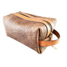 A brown leather Dopp Kit with a tan zipper and handle, utilizing the acrylic template for construction.