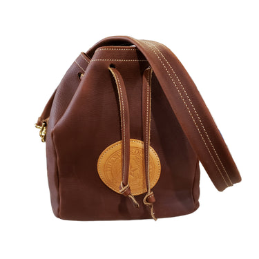 A brown drawstring bag with a leather accent and a metal clasp, displayed on a white background.