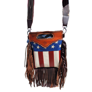 A cowhide bag with a stars and stripes pattern, resembling the American flag, and fringed tassels.