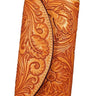 A brown leather clutch wallet with tooled floral patterns on the front and back.