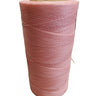 A spool of pink hand sewing thread on a white background.